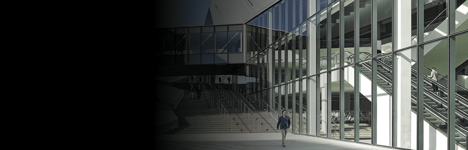 Banner showing an exterior building with a person walking alongside.